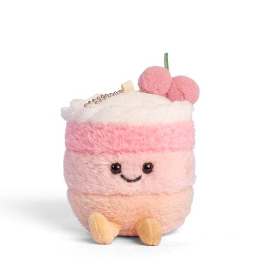 Pink cake plush keychain featuring a smiling cake plushy cream filling and a cherry topping