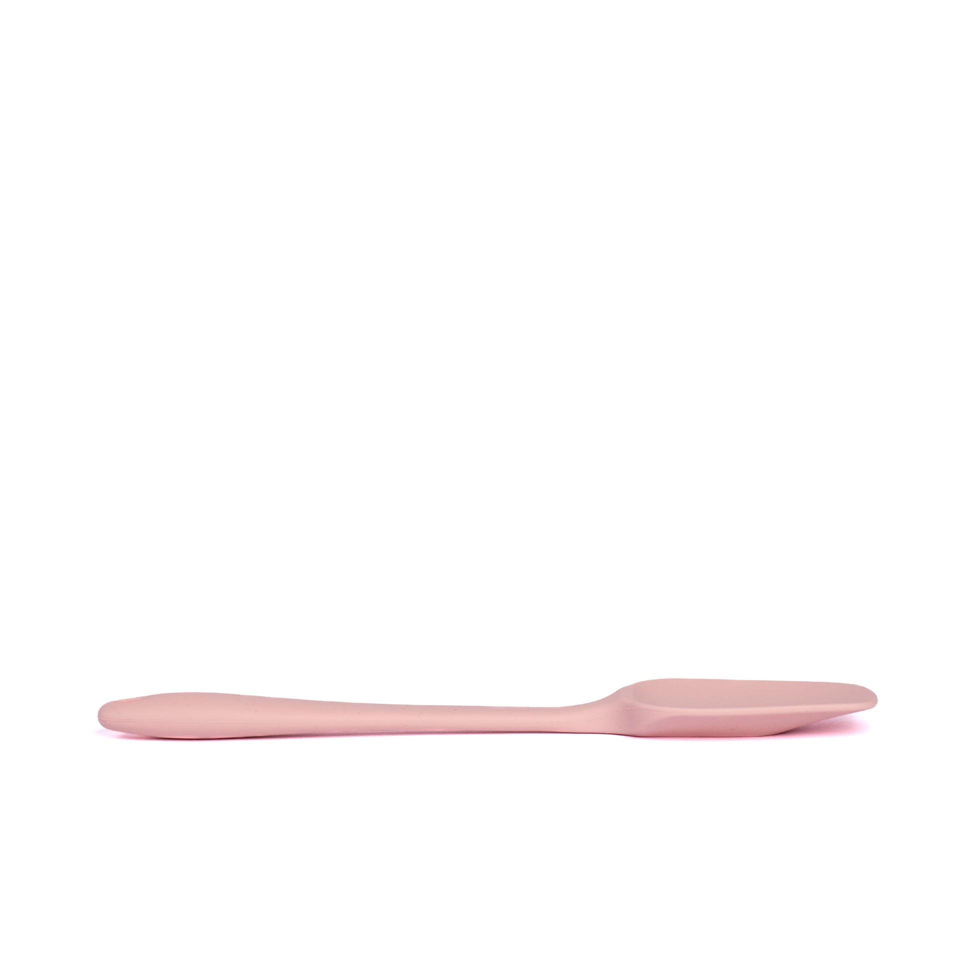 Side view pink silicone spatula for mixing cake batter scraping bowls folding ingredients spreading frosting and preparing homemade dessert recipes