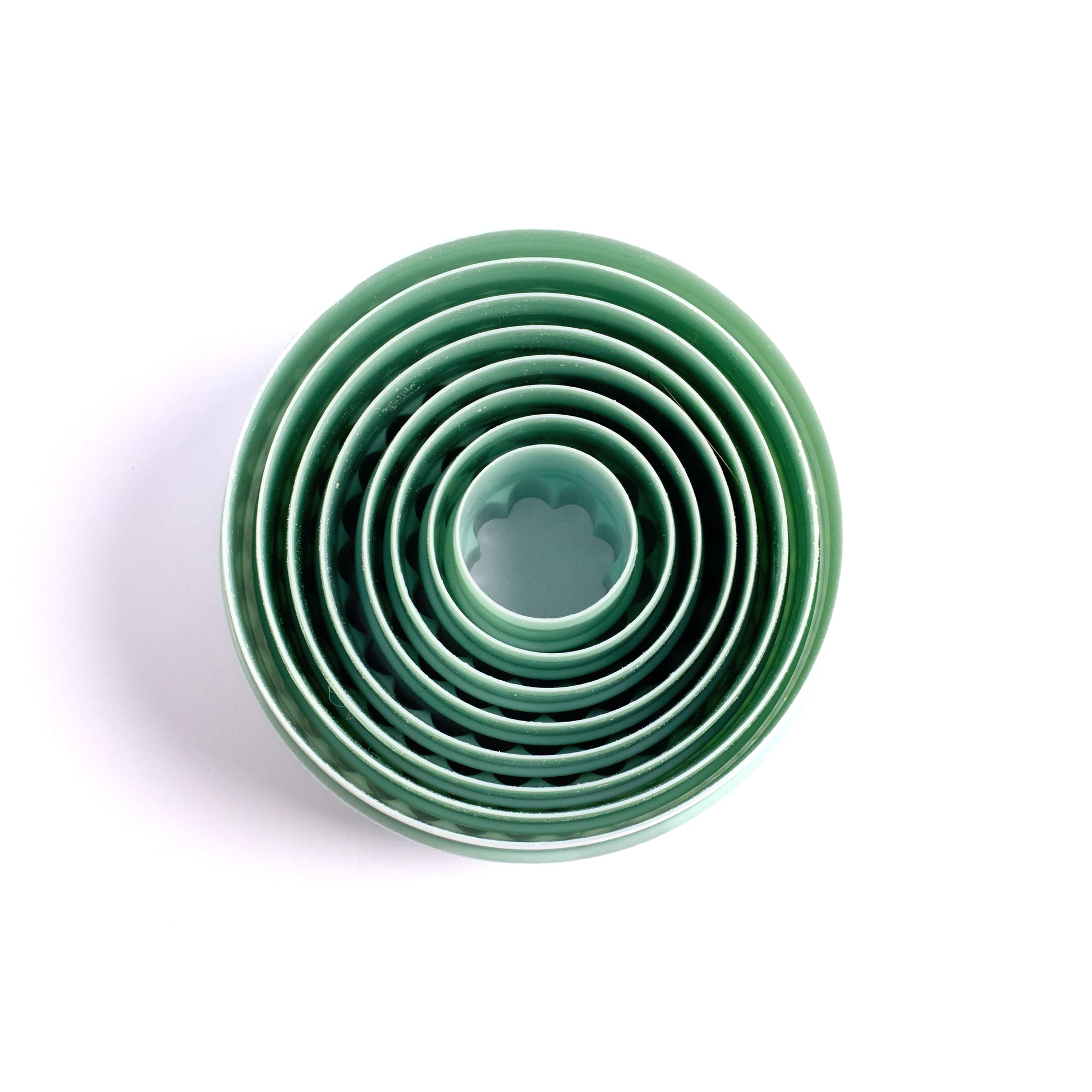Top view of nested mint green cookie cutter set in multiple sizes with smooth edges
